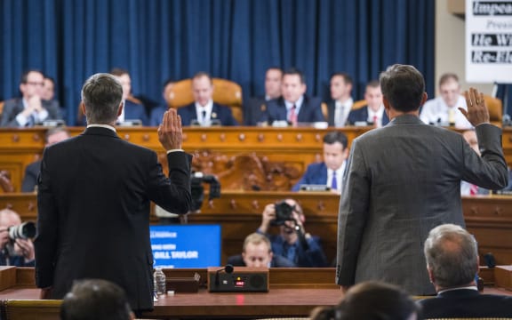 Charge d'Affaires at the US embassy in Ukraine Bill Taylor (left) and Deputy Assistant Secretary of State for Europe and Eurasia George Kent (right) are sworn in to testify before the House Permanent Select Committee on Intelligence hearing on the impeachment inquiry into President Trump