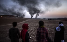 Smoke rises from the town of Kobane yesterday at the Turkish border near the southeastern village of Mursitpinar.