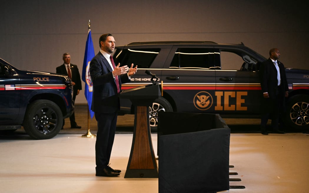 ICE vehicles sit in the background as US Vice President JD Vance speaks at Royalston Square in Minneapolis, Minnesota, on 22 January, 2026.
