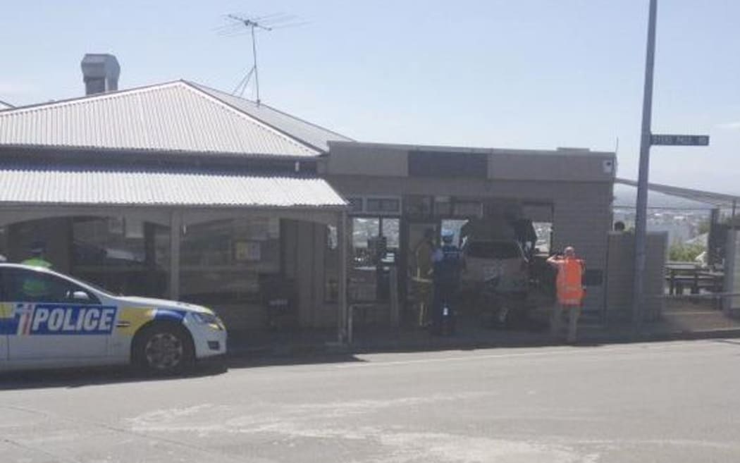 A photo posted today on Twitter shows the taxi inside the cafe and police at the scene.