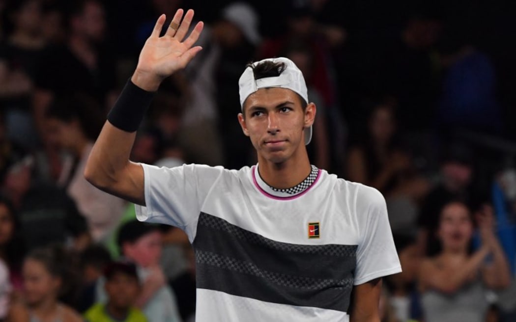 Australia's Alexei Popyrin reacts after the retirement of Austria's Dominic Thiem during their men's singles match at  the Australian Open tennis tournament in Melbourne on January 17, 2019.