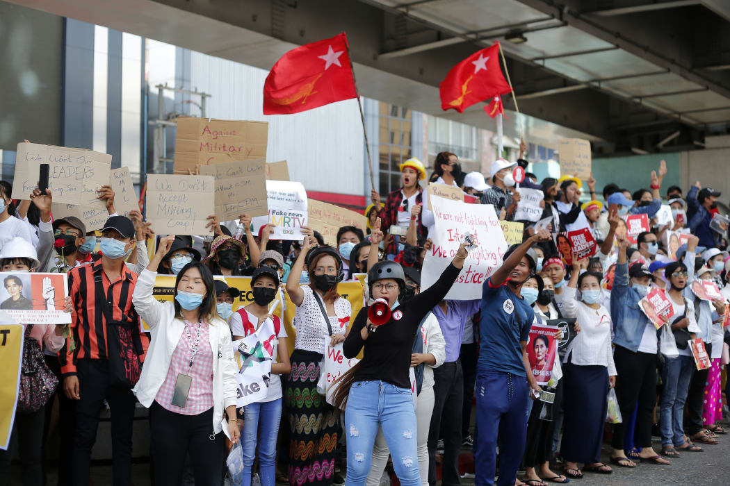 Myanmar protesters shout slogans and hold placards during a demonstration against military coup in Yangon, Myanmar