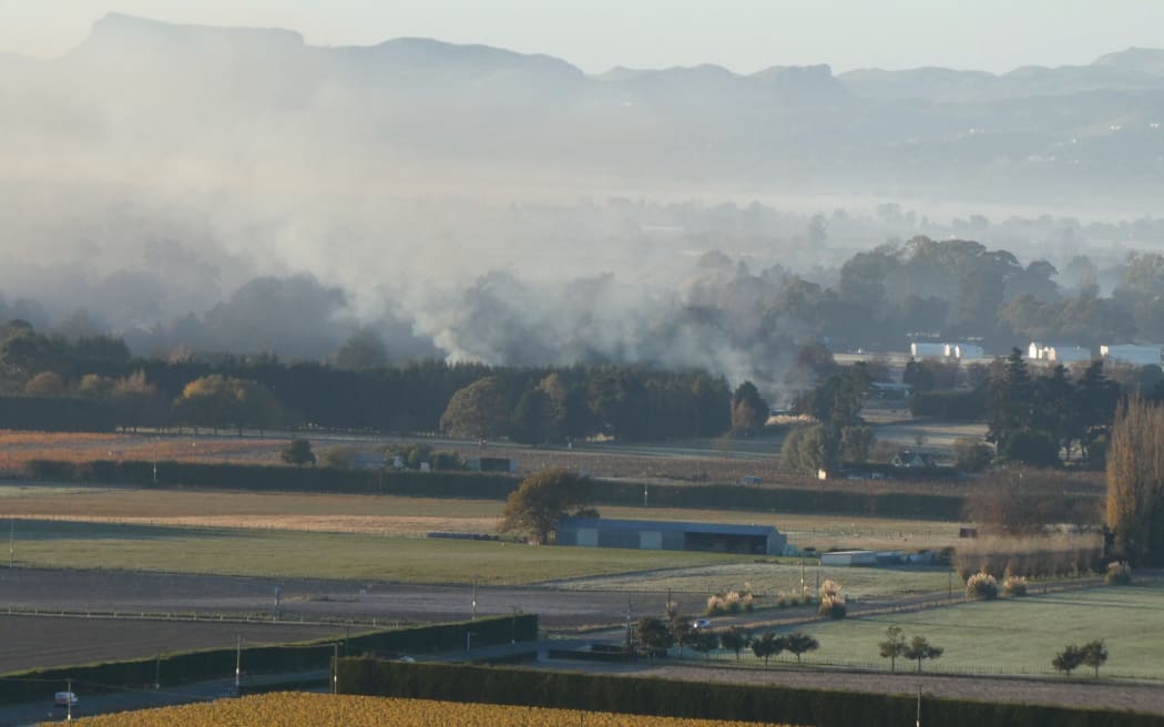 Former council chair Rex Graham claims this photo shows smoke from orchard burnoffs over the Heretaunga Plains, but the council denies that.