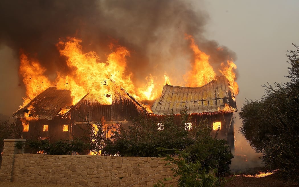 Fire consumes a barn as an out of control wildfire moves through Glen Ellen in California.