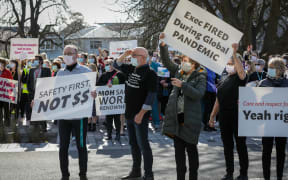 Hundreds of protesters gather outside of the CHB corporate office.