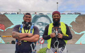 Poihakena Ngawati and Te Haunui Tuna with their mural in the background in Hamilton