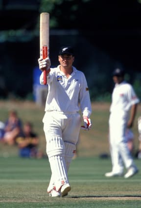 Batsman (and later captain) Ken Rutherford holds his bat up to acknowledge the crowd.