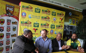PNG Rugby League chairman Sandis Tsaka (L) shakes hands with new Papua New Guinea Hunters coach Matt Church.