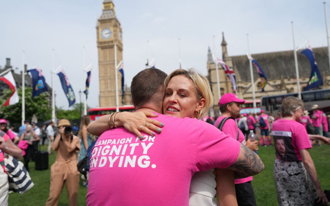 Campaigners, for a change in the law on assisted dying celebrate outside The Palace of Westminster, home to the Houses of Parliament in central London, on 20 June, 2025, after the vote on whether to allow assisted dying for terminally ill people.