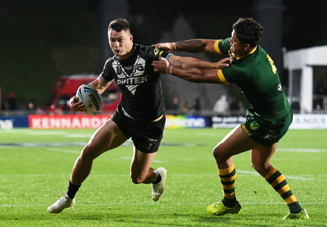 Young Kiwis star Joseph Manu puts a fend on Kangaroos opposite and Roosters team-mate Latrell Mitchell.