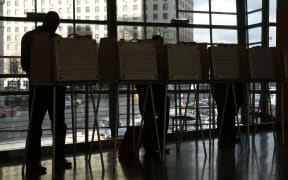 People fill out their absentee ballots at the Rosa Parks Transit Station in Detroit, Michigan.
