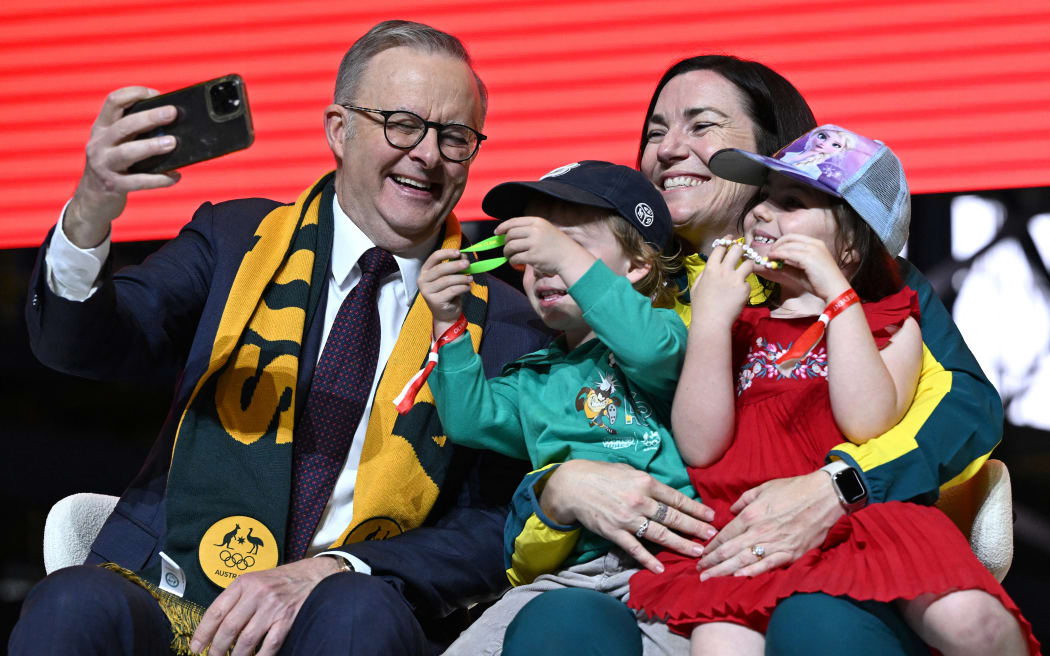 Australia's Prime Minister Anthony Albanese takes selfies with Australia's chef de mission for Paris 2024 Anna Meares and her children during an event following the return of athletes to Australia, 14 August, 2024. (Photo by Saeed KHAN / AFP)