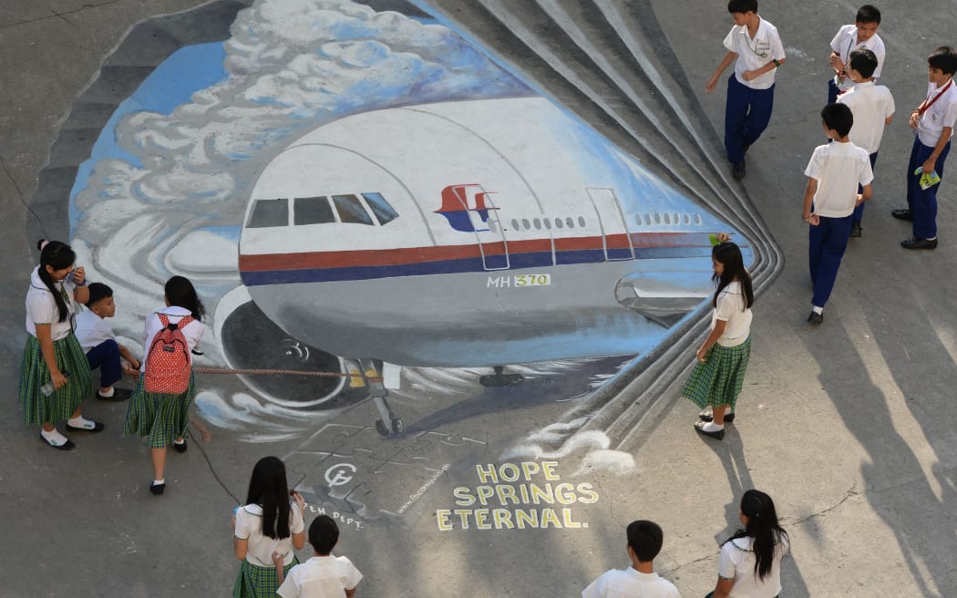 A giant mural of the missing Malaysian plane at a Manila schoolground.
