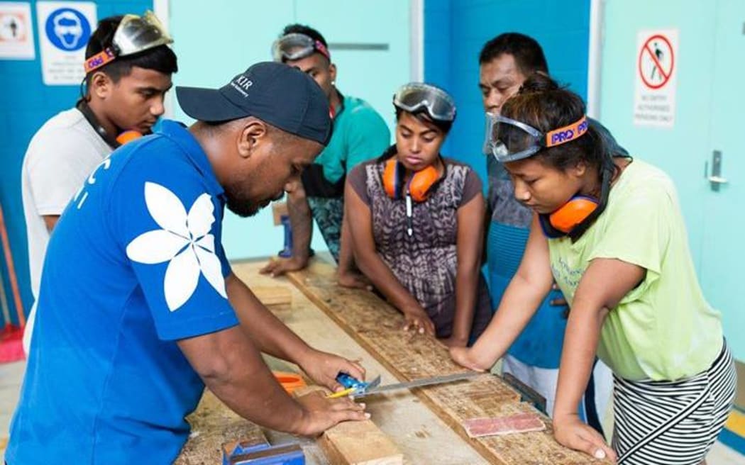 Students in Kiribati learning technical skills.