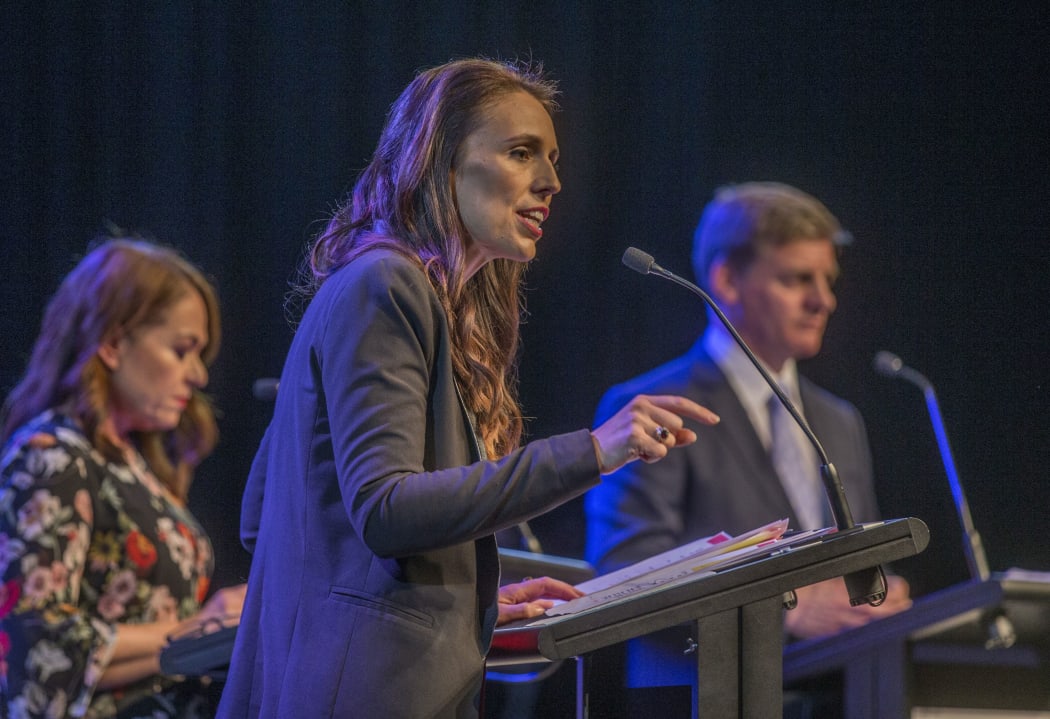 Jacinda Ardern, centre, and Bill English, right, in the third leaders debate.