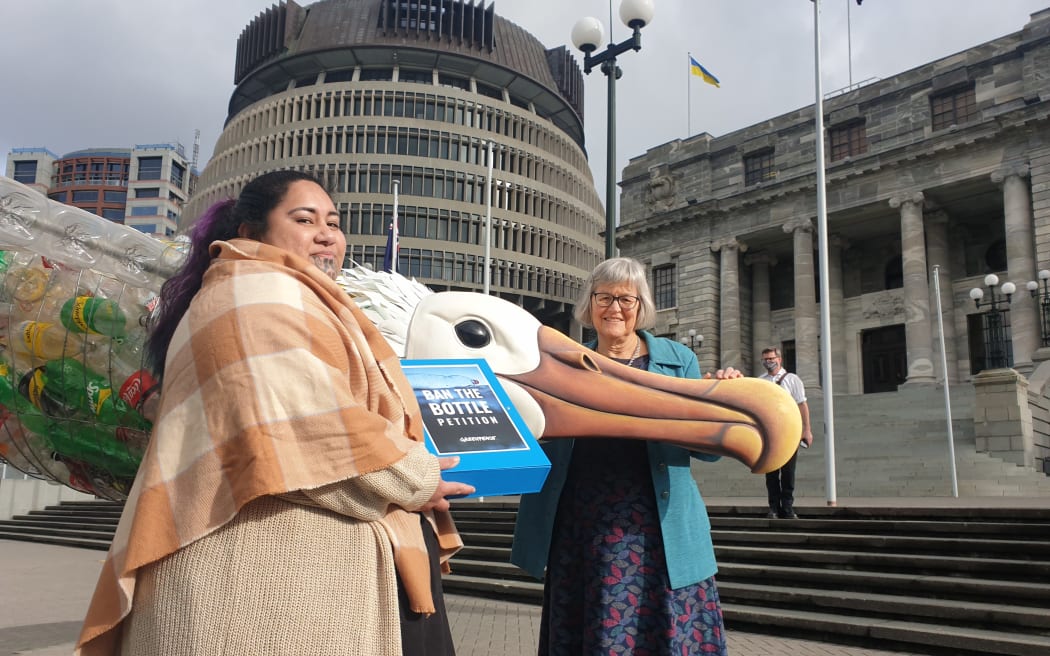 Greenpeace plastics campaigner Juressa Lee presents petition to Green MP Eugenie Sage signed by 100,000 people calling on the government to ban single-use plastic bottles on 30 June 2022.