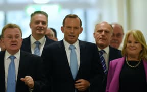 Australian Prime Minister Tony Abbott (centre) leaves after a special Liberal party room meeting at Parliament House in Canberra.