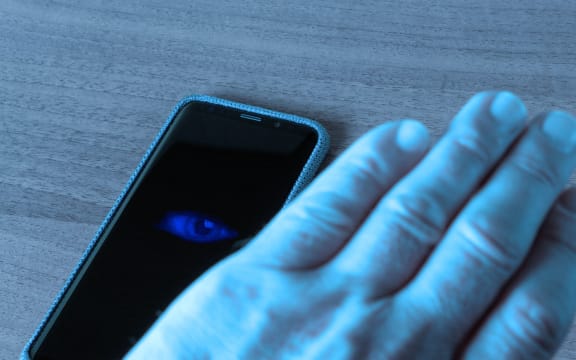 Phone spying on man.