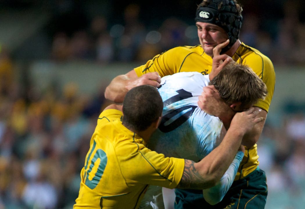 Toby Flood is wrapped up by Quade Cooper and Deam Mumm. Australia Wallabies v England. International Rugby Match. Perth, Western Australia. Saturday 12 June 2010. Photo: Daniel Carson|PHOTOSPORT