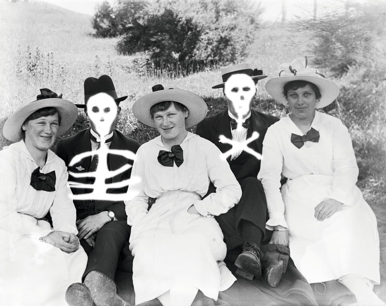 Group sitting in a field, c. 1917–20