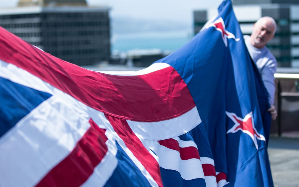 Parliament's acting facilities engineering manager Steve Barron displays one of the blue ensigns that fly atop the Beehive. The flag is approximately five metres long.