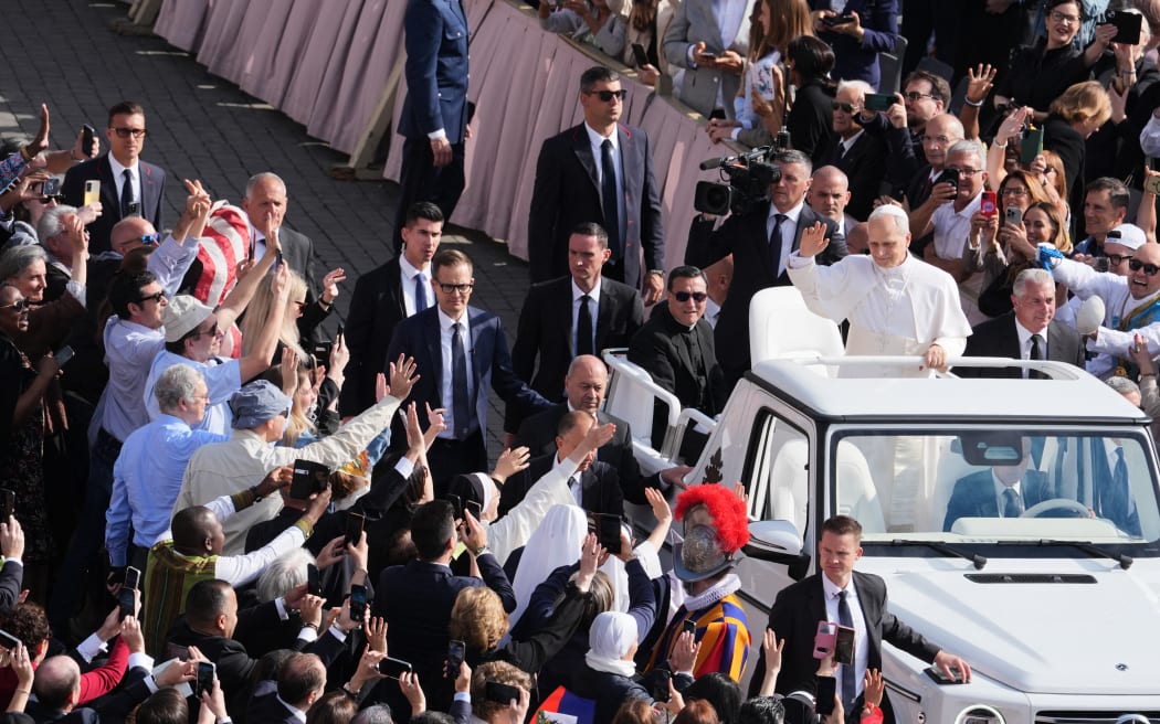 Pope Leo XIV greets the crowd from the popemobile before a Holy mass for the beginning of his pontificate, in St Peter's square in The Vatican on May 18, 2025. (Photo by Jacquelyn Martin / POOL / AFP)