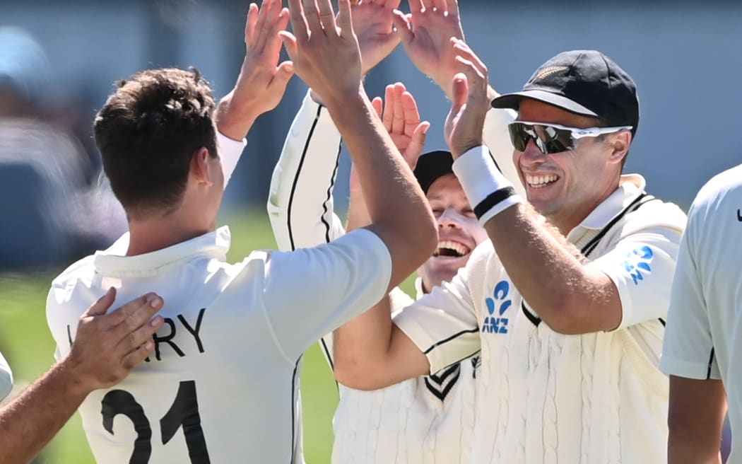 Matt Henry, Henry Nicholls and Tim Southee celebrate the wicket of Kagiso Rabada during play on day one of the first cricket test between South Africa and New Zealand at Hagley Oval in Christchurch, New Zealand.
