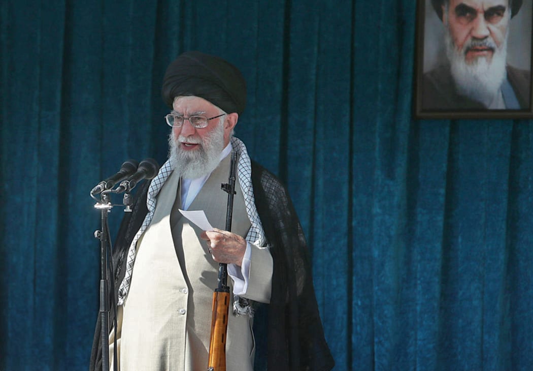 This file handout picture provided by the Iranian supreme leader office on June 5, 2019 shows the Islamic republic's supreme leader, Ayatollah Ali Khamenei, holding a rifle as he delivers the Eid al-Fitr sermon during prayers.
