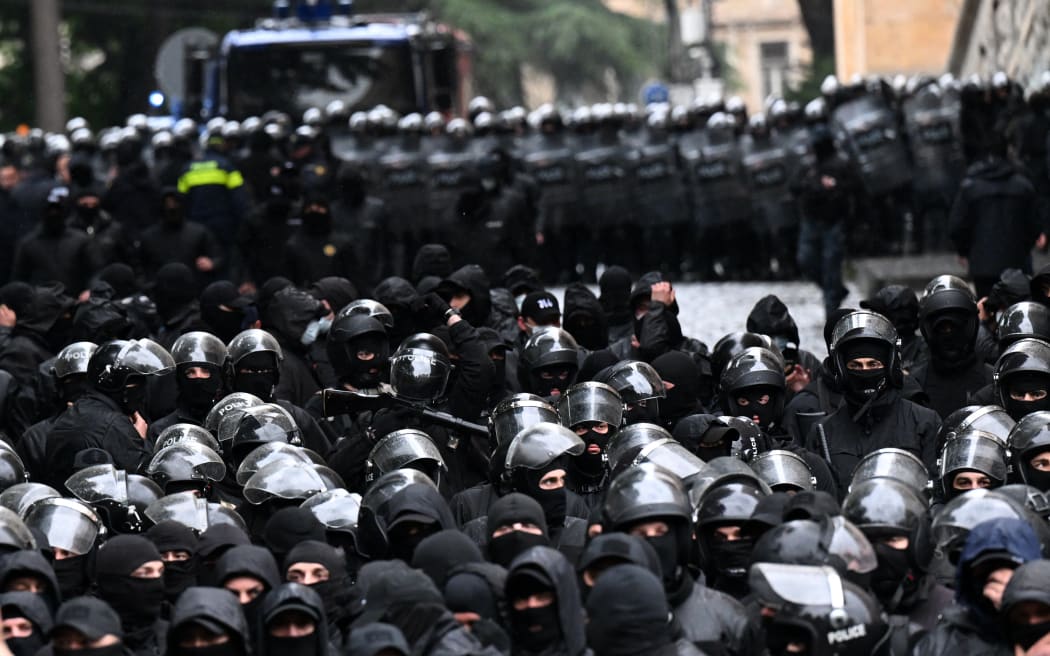 Georgian law enforcement officers are seen deployed on streets as protesters rally against the controversial "foreign influence" bill in Tbilisi on May 14, 2024. Georgia's parliament on May 14, 2024 adopted a controversial "foreign influence" law that has sparked weeks of mass protests against the measure, denounced as mirroring Russian legislation used to silence dissent. The bill requires non-governmental organisations and media outlets that receive more than 20 percent of their funding from abroad to register as bodies "pursuing the interests of a foreign power." (Photo by Vano SHLAMOV / AFP)