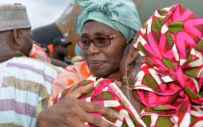 The wife of Cameroon's deputy prime minister hugs a relative in Yaounde, after she was freed following her kidnapping in a raid blamed on Boko Haram.