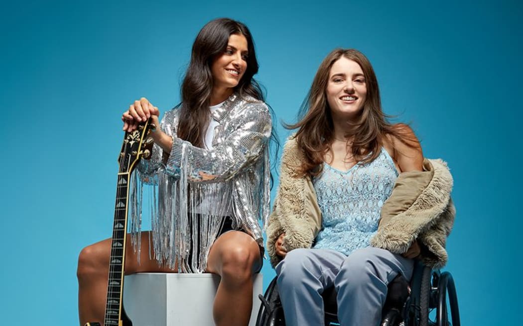 Sophia and Indy with a guitar