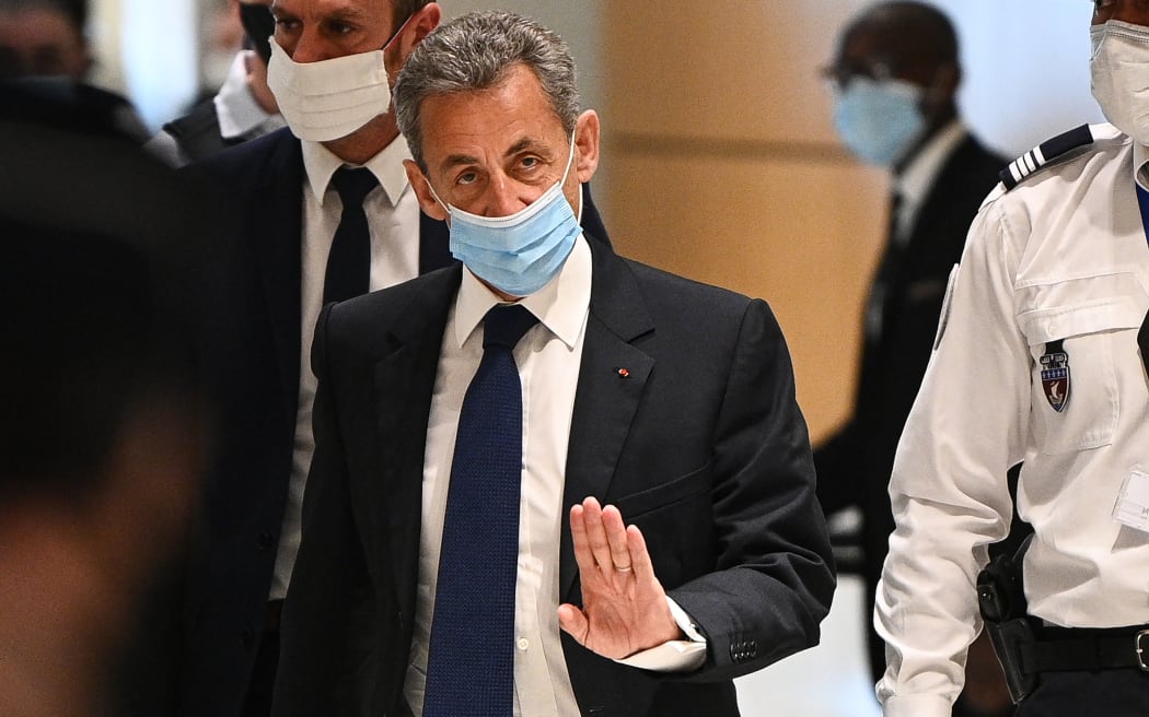 Former French president Nicolas Sarkozy arrives at a Paris courthouse to hear the final verdict in a corruption trial on 1 March 2021.