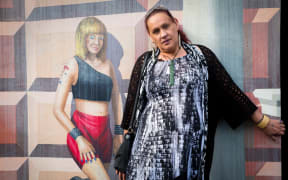 Kayla Riarn with the famous mural on Marion Street, Te Whanganui-ā-Tara.