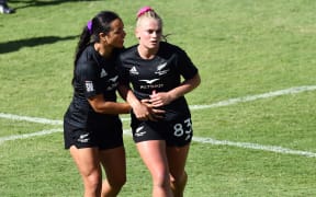 New Zealand's Jorja Miller (R) is consoled by Stacey Waaka during their quarter-final against Australia at the Perth leg of the sevens world series.