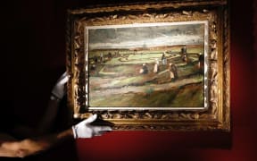 The painting "Raccommodeuses de filet dans les dunes" by Dutch painter Vincent van Gogh is presented at Artcurial auction house in Paris.