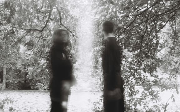 Man and woman separated by a pillar of light