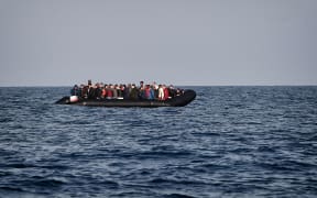 A rubber boat with migrants is seen off the Libya coast (file image).