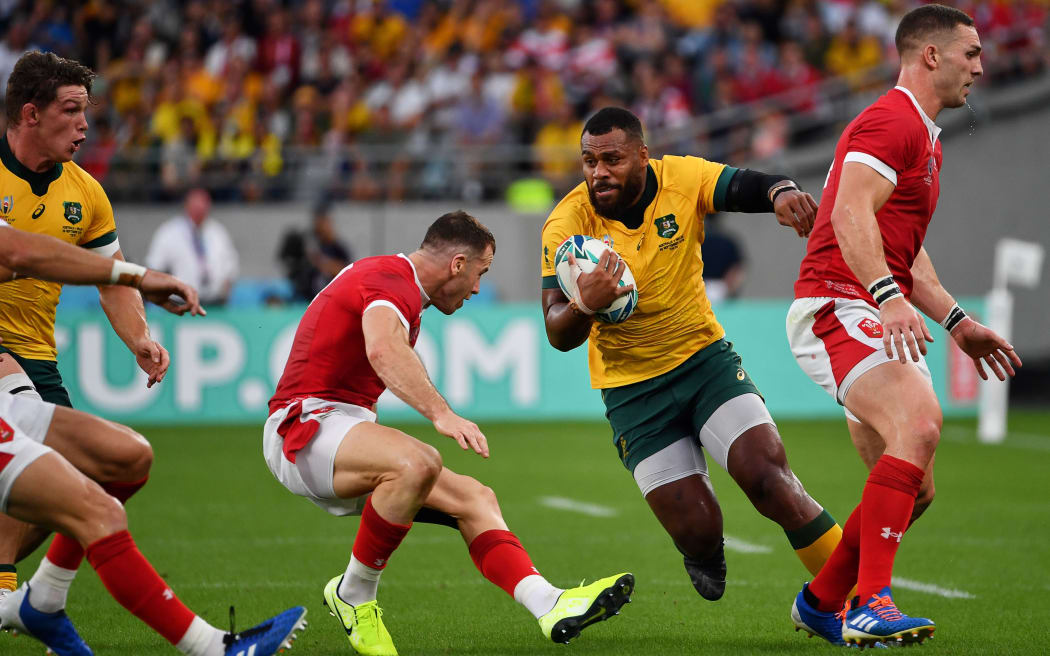 Australia's centre Samu Kerevi (2R) runs with the ball during the Japan 2019 Rugby World Cup Pool D match between Australia and Wales at the Tokyo Stadium in Tokyo.