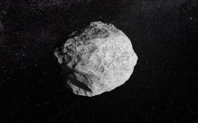 An artist's impression depicts an asteroid orbiting the sun.