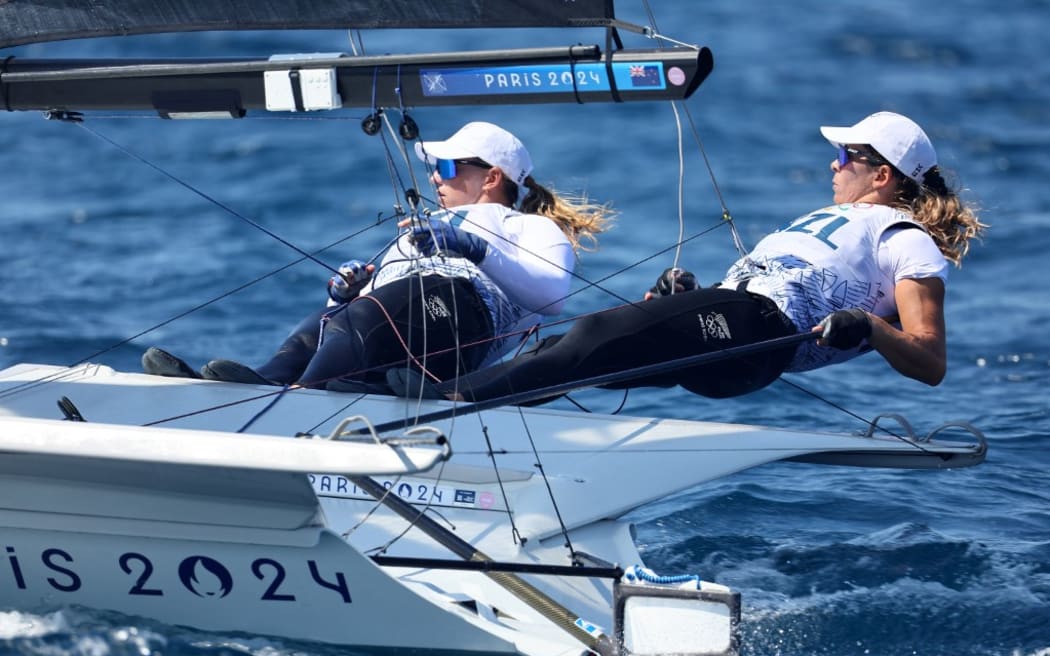 New Zealand's duo Jo Aleh and Molly Meech compete in the medal race of the women’s 49erFX skiff event during the Paris 2024 Olympic Games sailing competition at the Roucas-Blanc Marina in Marseille on August 2, 2024. (Photo by Clement MAHOUDEAU / AFP)