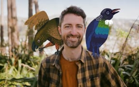 Bird guy David Klein smiles at the camera with cartoon birds sitting on his shoulders.