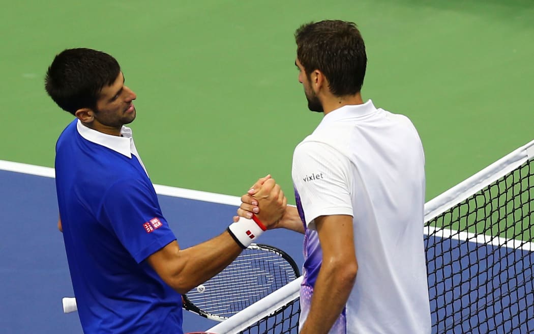 Novak Djokovic (L) greets Marin Cilic at the net after their match in New York