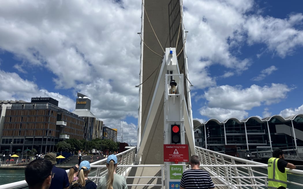 Te Wero Wynyard Crossing Bridge is raised to allow a boat to pass through.