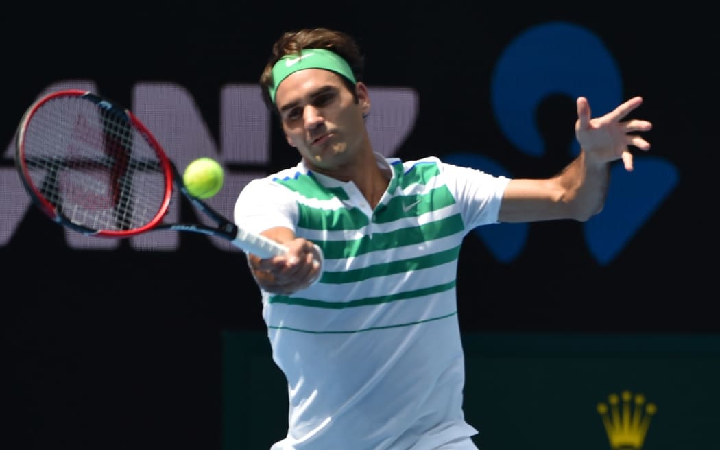 Switzerland's Roger Federer hits a return during his men's singles match against Czech Republic's Tomas Berdych at the 2016 Australian Open, January 26, 2016. AFP PHOTO / SAEED KHAN