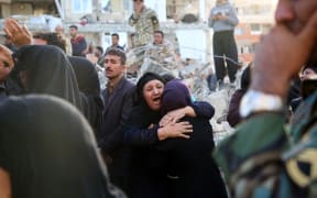 Survivors in shock amid the destruction in Sarpol-e Zahab province, Kermanshah, Iran.