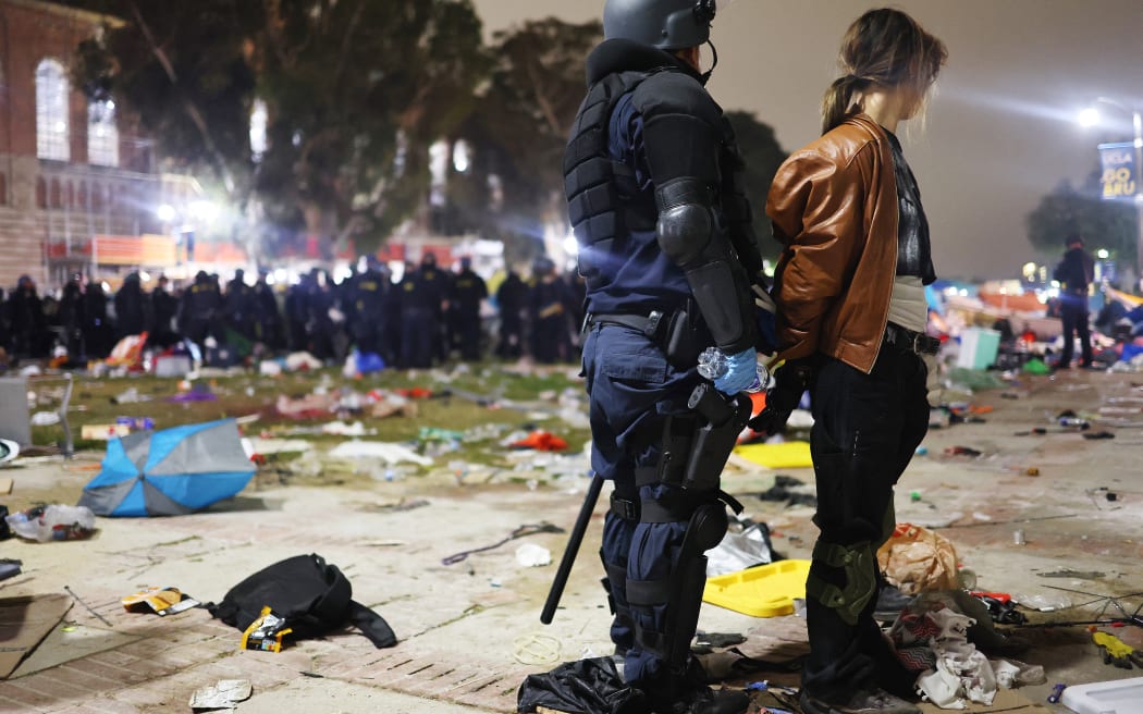 LOS ANGELES, CALIFORNIA - MAY 02: A California Highway Patrol (CHP) officer detains a protestor while clearing a pro-Palestinian encampment after dispersal orders were given at the University of California, Los Angeles (UCLA) campus, on May 2, 2024 in Los Angeles, California. The camp was declared ‘unlawful’ by the university and over 100 protestors who refused to leave were detained during the operation. Pro-Palestinian encampments have sprung up at college campuses around the country with some protestors calling for schools to divest from Israeli interests amid the ongoing war in Gaza.   Mario Tama/Getty Images/AFP (Photo by MARIO TAMA / GETTY IMAGES NORTH AMERICA / Getty Images via AFP)