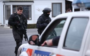 Armed police walk into Ashburton Police Station.