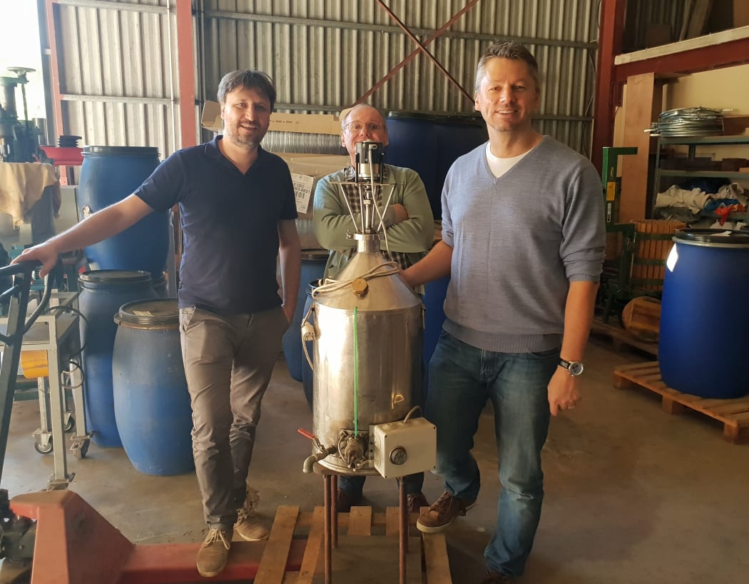 Michael Oelgemöller from James Cook University (right) at a distillery in New Caledonia.