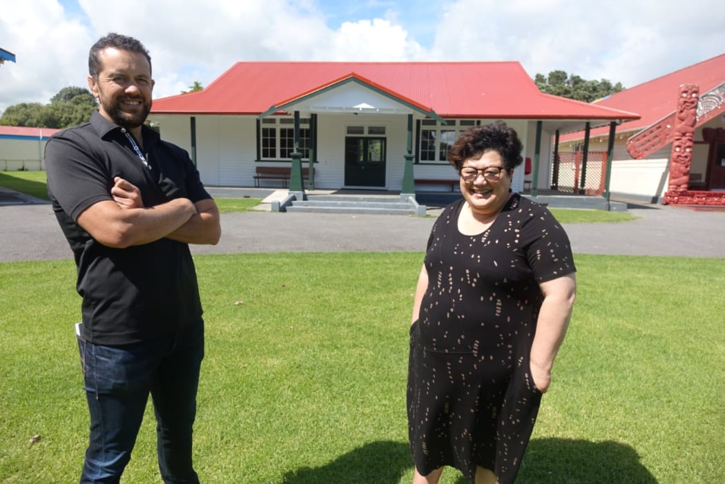 Ānaru White and Wikitoria Michalanney in front of Tama Tāne whare.