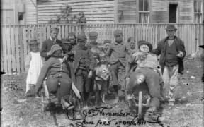 Children with rival guys, Guy Fawkes day at Ohingaiti. c1900